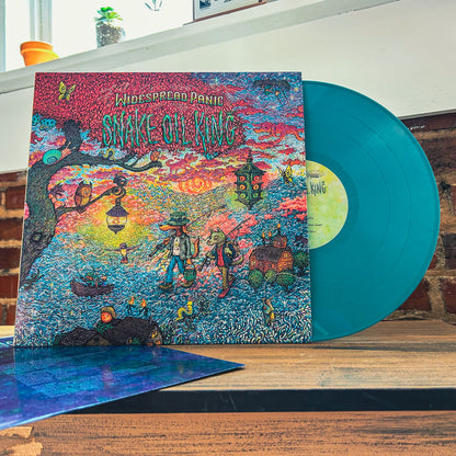 An image of the Snake Oil King vinyl being displayed on a wooden surface