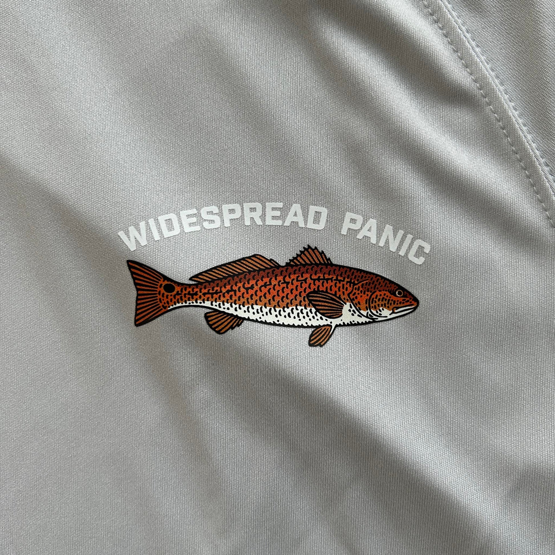 An upclose image of the Redfish logo on the front of the Redfish long-sleeve hooded fishing shirt